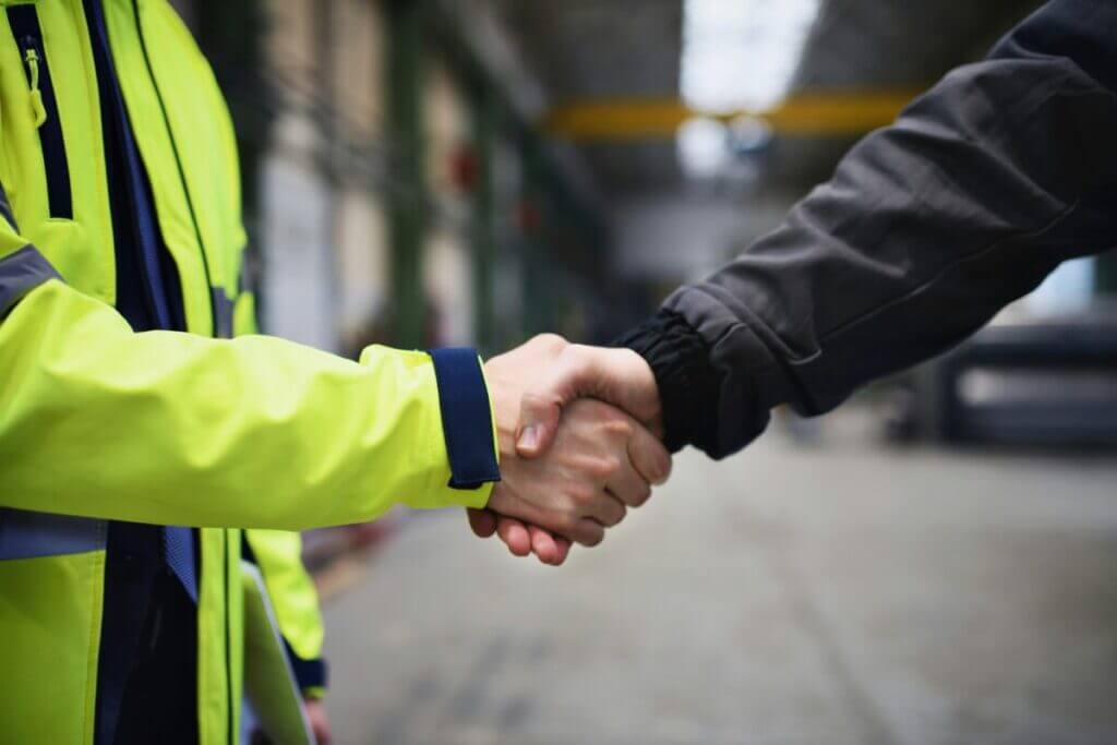 two person hand shake in a workplace