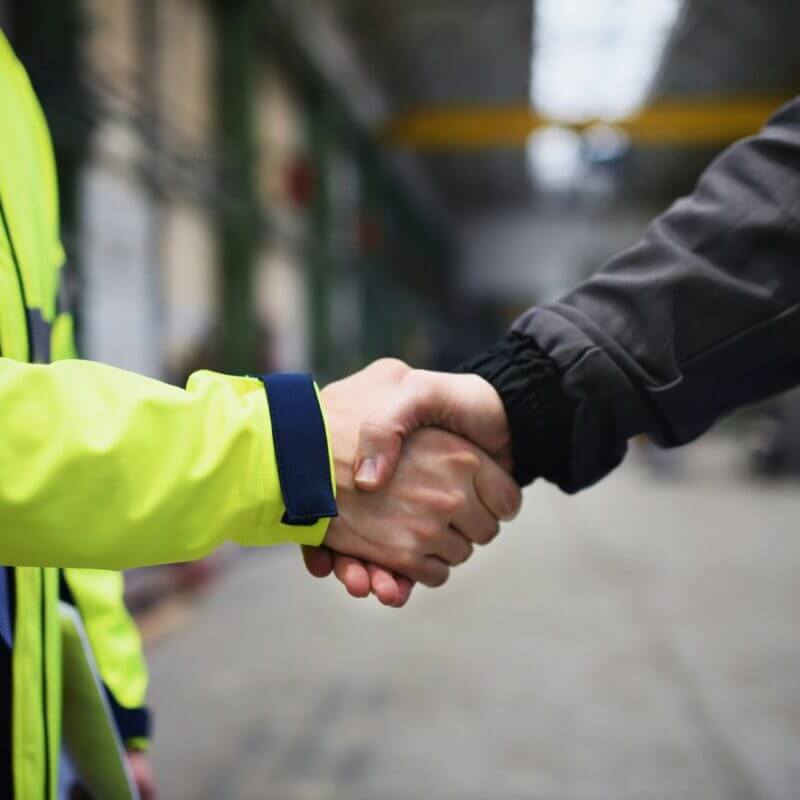two person hand shake in a workplace