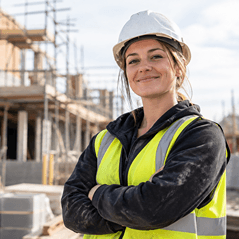 Confident female construction contractor highlighting the effective use of a construction safety management system being used for contractors and contractor management on site.